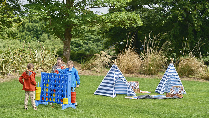 Children playing with garden games at Platform 22 at the Barnagh Greenway Hub
