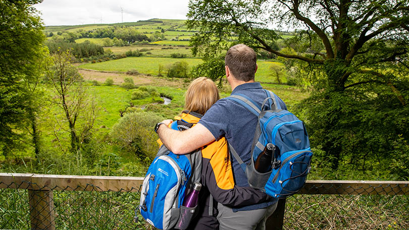 Couple looking at the view at Tullig Wood on Limerick Greenway