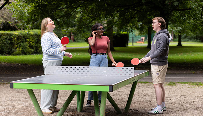 Three people playing table tennis at O'Brien Park in Limerick