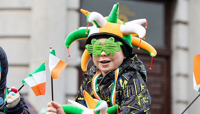  Young boy with Irish flag, green, white and gold jesters hat and green shamrock glasses watching the Limerick St. Patrick's Day parade. Photo: Sean Curtin True Media