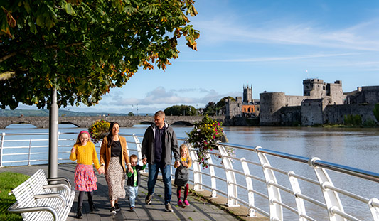 Family walking on The Three Bridges Walk in Limerick