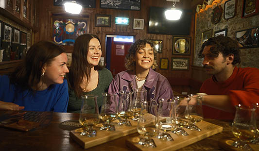Four people enjoying the Limerick Whiskey Experience in Mother Macs pub in Limerick City. Photo: Ireland's Content Pool