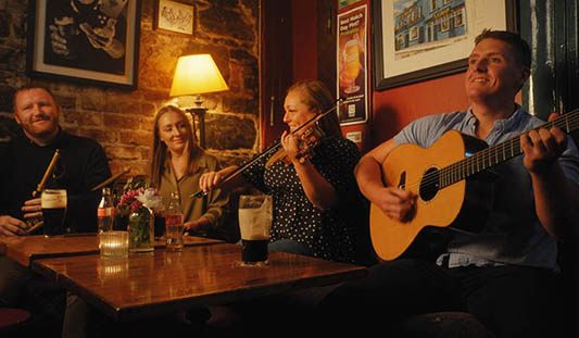 Four musicians at a trad session in Dolan's Pub in Limerick