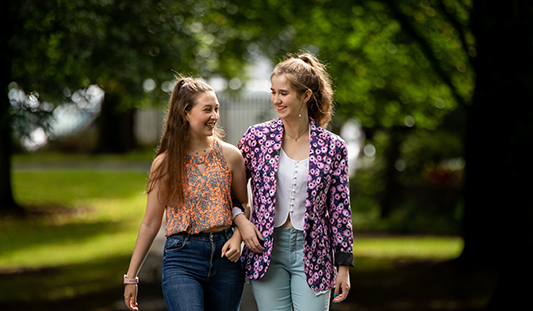 Two young women walking in People's Park Limerick