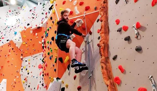 Man climbing a wall at the UL Sport Climbing Wall