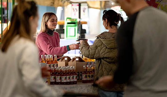 Woman buying jam at a stall in Limerick Milk Market.