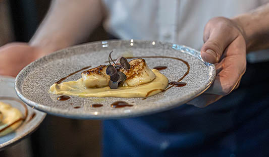 Waiter carrying a plate of food