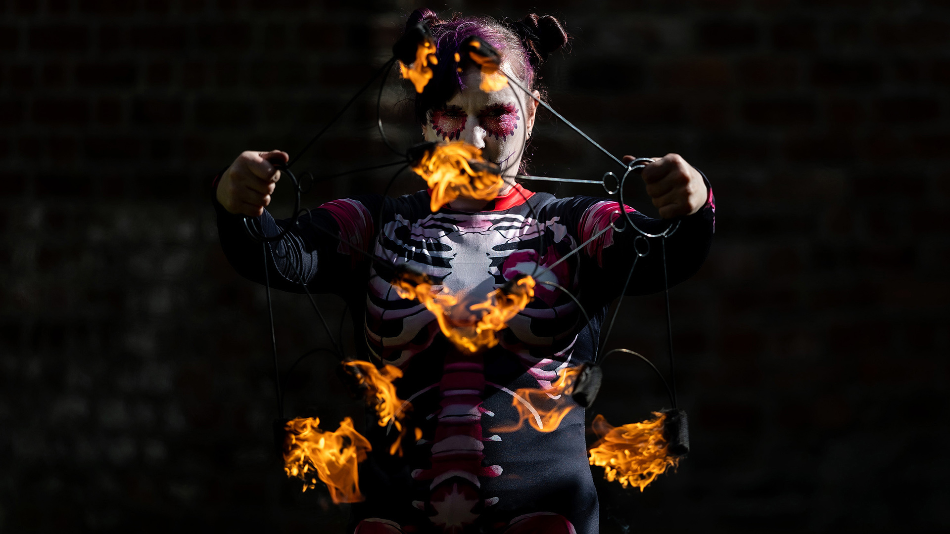 Fire performer in Halloween makeup and costume