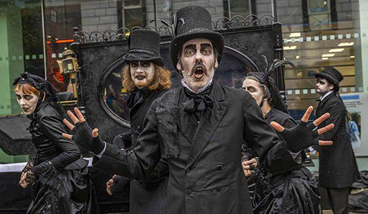 Performers from Morbid and Sons dressed in black funeral attire during an event for Halloween in Limerick. Photo: Kieran Ryan Benson
