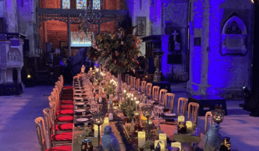 Long table dinner setting in a blue lighting inside St. Mary's Cathedral in Limerick
